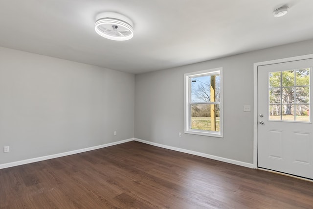 foyer with baseboards and dark wood-style floors