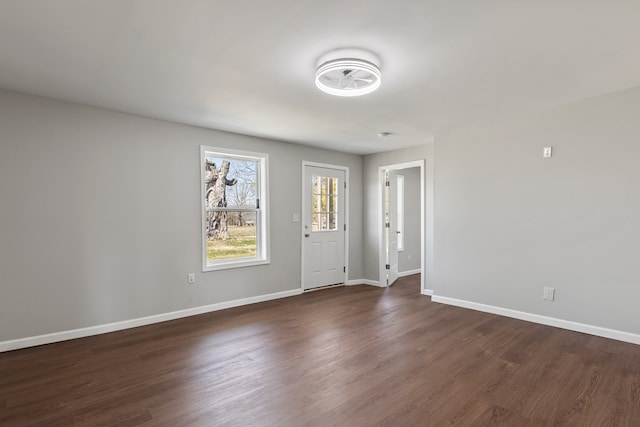 entryway featuring baseboards and dark wood-style flooring