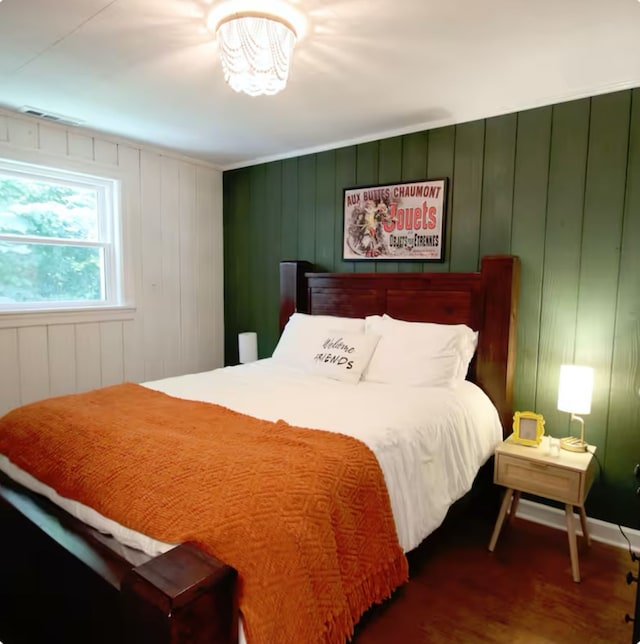 bedroom with dark wood-style flooring