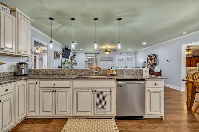 kitchen with decorative light fixtures, cream cabinets, stainless steel dishwasher, a ceiling fan, and a sink