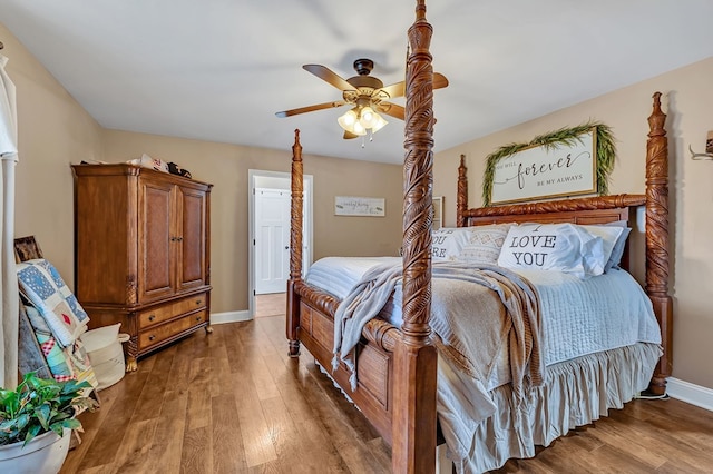 bedroom featuring dark wood finished floors, a ceiling fan, and baseboards