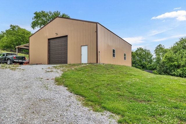 detached garage with gravel driveway