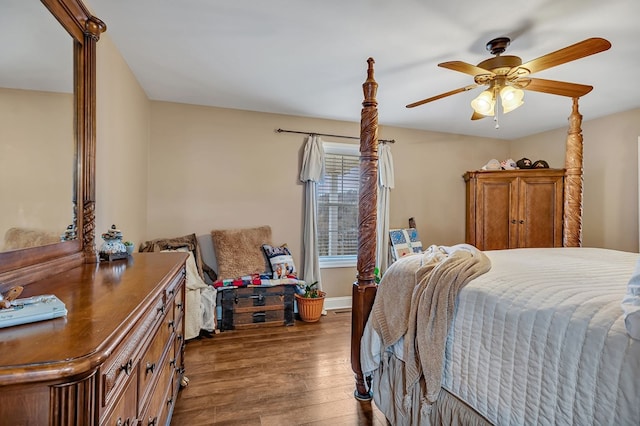 bedroom featuring dark wood-style floors, baseboards, and a ceiling fan