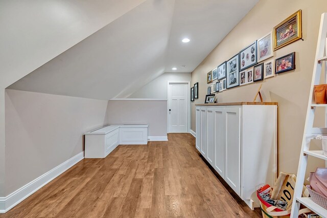 bonus room featuring lofted ceiling, baseboards, light wood finished floors, and recessed lighting