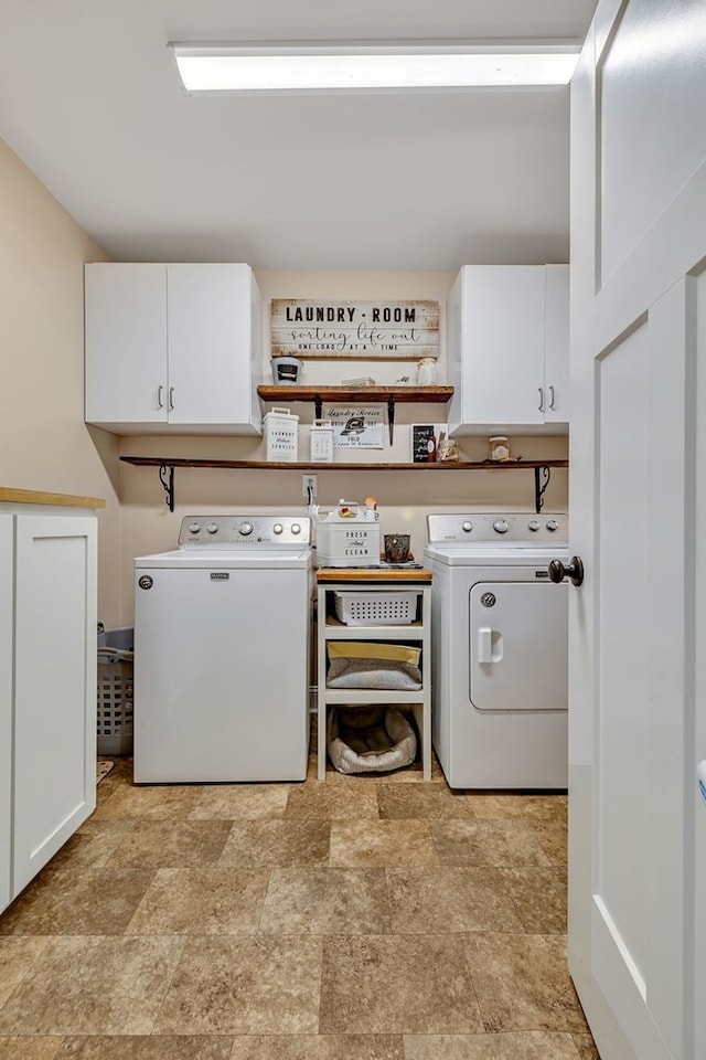 laundry room with separate washer and dryer, stone finish floor, and cabinet space