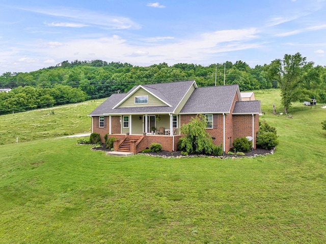 view of front facade featuring a front lawn, a porch, and brick siding