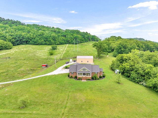 birds eye view of property with a rural view and a wooded view