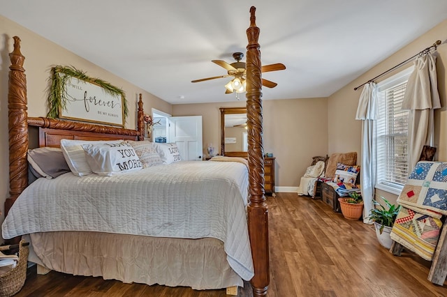 bedroom with a ceiling fan, baseboards, and wood finished floors