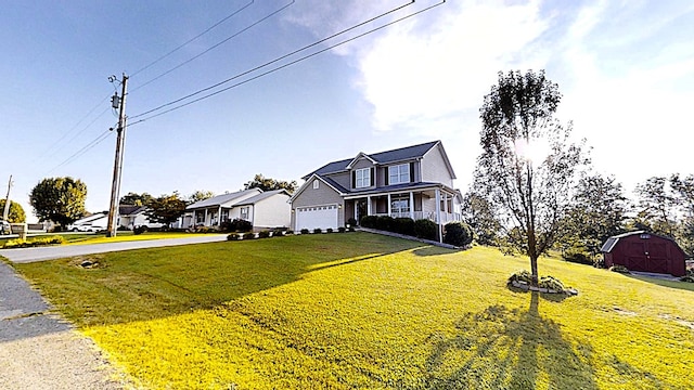 traditional-style house with a porch, a front yard, a garage, a residential view, and driveway