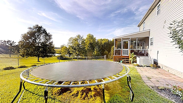 view of yard with fence and a sunroom