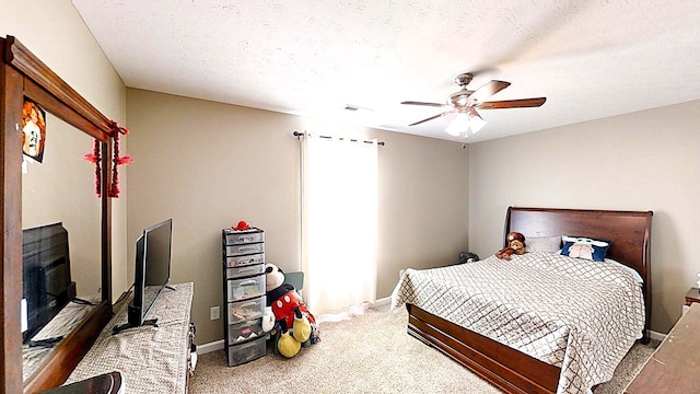 carpeted bedroom featuring a textured ceiling, ceiling fan, visible vents, and baseboards