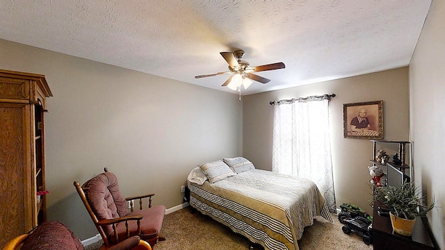 carpeted bedroom featuring a textured ceiling, a ceiling fan, and baseboards