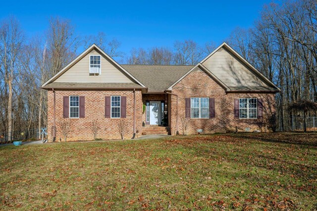 view of front of home with brick siding and a front lawn