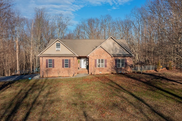 view of front of home with a front lawn and brick siding