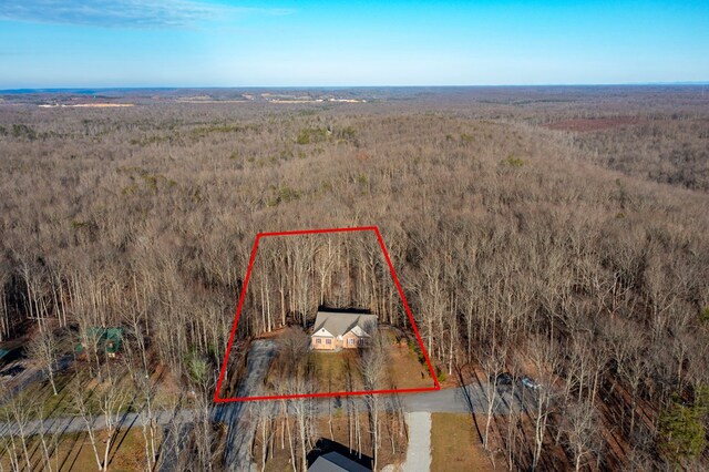 birds eye view of property featuring a view of trees