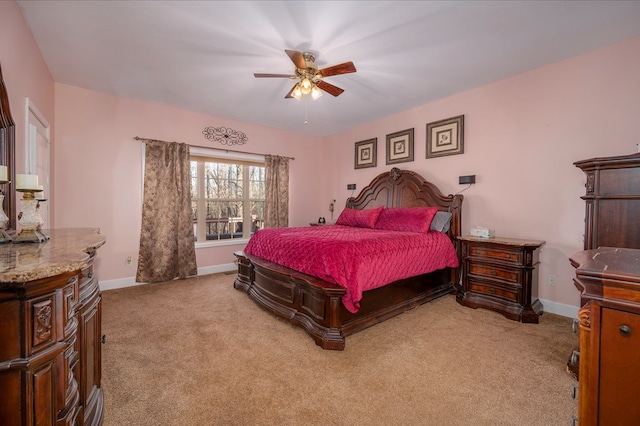 bedroom with baseboards, a ceiling fan, and light colored carpet