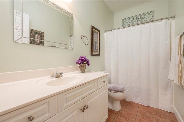 bathroom featuring tile patterned flooring, vanity, and toilet