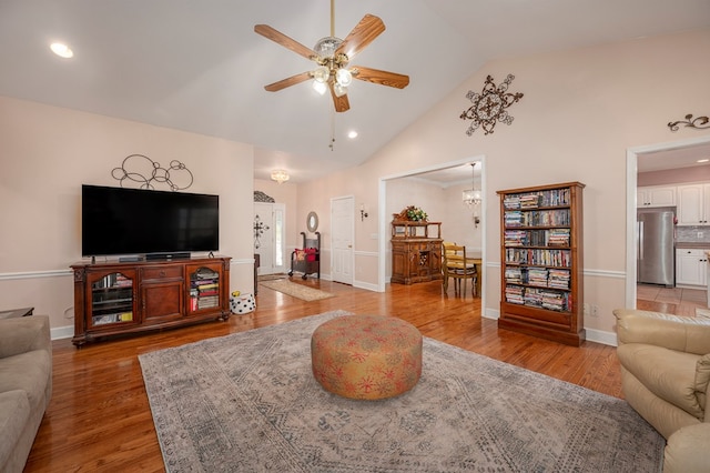 living room featuring ceiling fan, wood finished floors, and baseboards