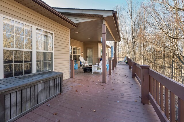 wooden terrace featuring a fire pit