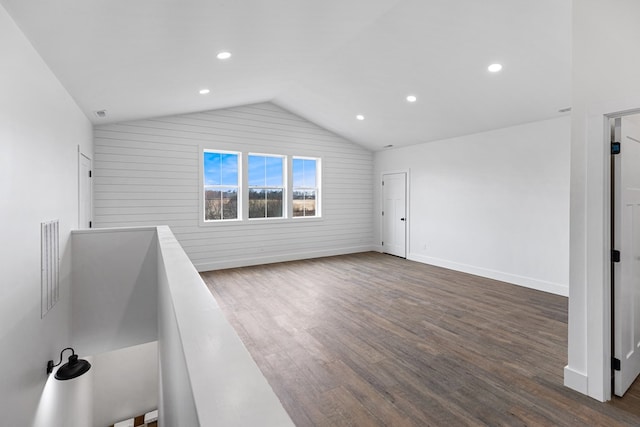 interior space with visible vents, baseboards, dark wood-style floors, vaulted ceiling, and recessed lighting