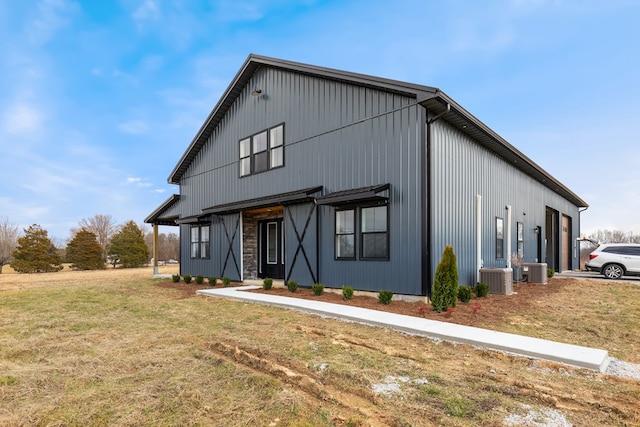 modern inspired farmhouse with central AC unit and a front lawn