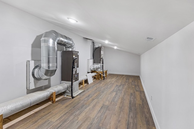 interior space featuring visible vents, dark wood finished floors, and baseboards