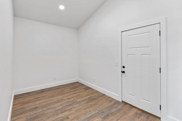 unfurnished room featuring baseboards, dark wood-type flooring, and recessed lighting