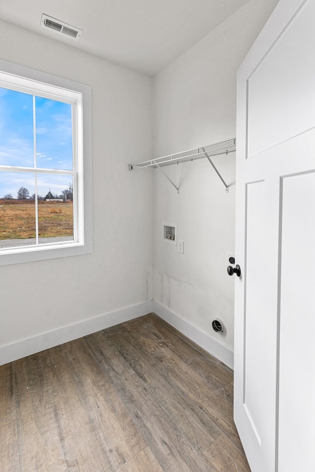 washroom featuring laundry area, hookup for a washing machine, visible vents, and wood finished floors