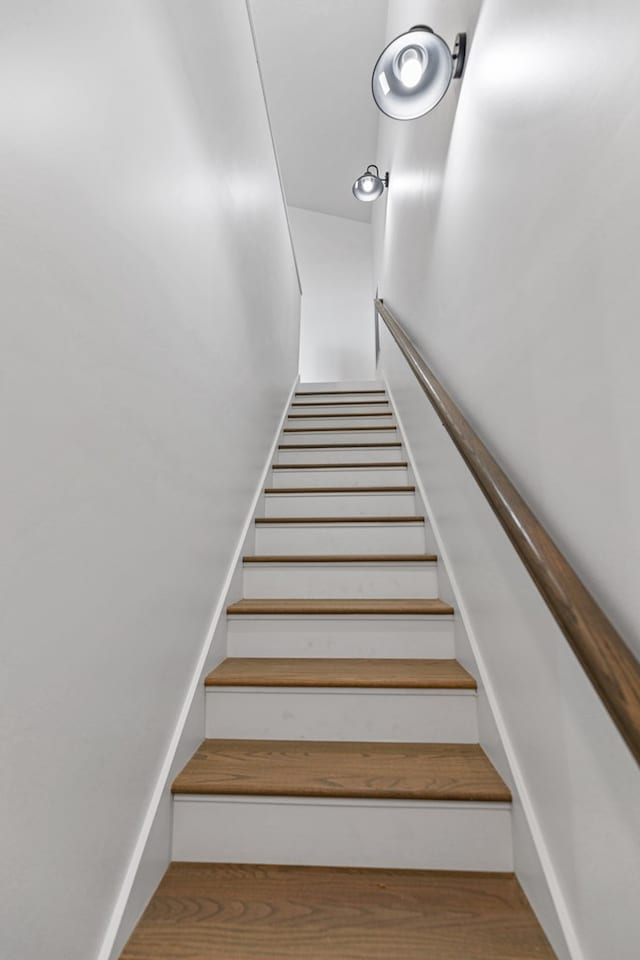 stairs featuring wood finished floors