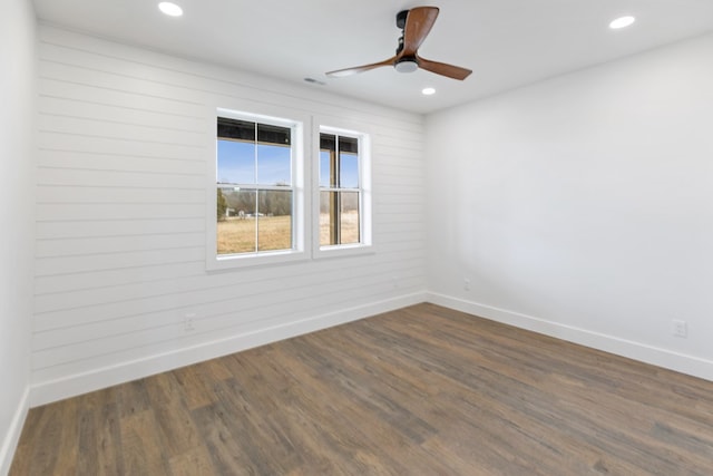 unfurnished room with recessed lighting, dark wood finished floors, a ceiling fan, and baseboards