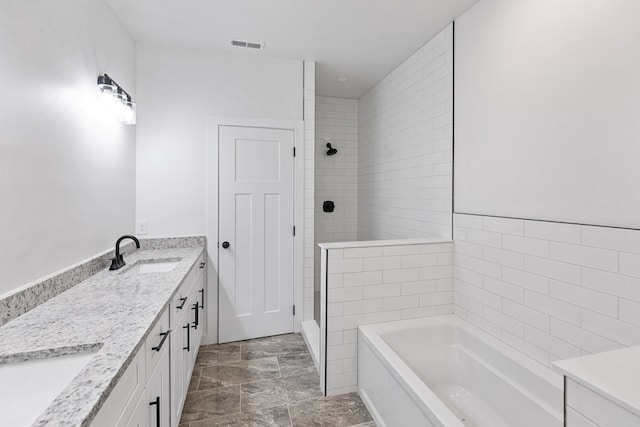 full bathroom featuring double vanity, visible vents, tiled shower, a garden tub, and a sink