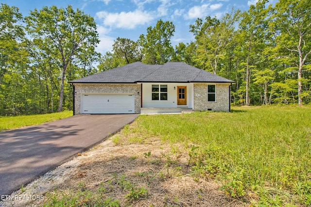 view of front facade featuring aphalt driveway, a garage, brick siding, a shingled roof, and crawl space