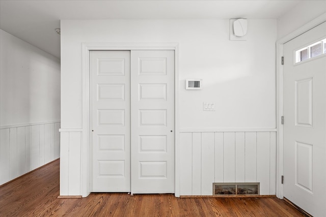 interior space featuring a wainscoted wall and wood finished floors