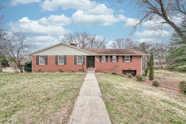 view of front facade with a chimney, brick siding, crawl space, and a front yard