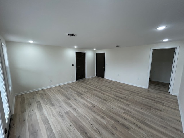 spare room featuring recessed lighting, visible vents, baseboards, and light wood-style floors