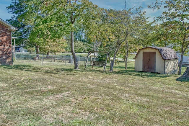 view of yard featuring fence, an outdoor structure, and a storage unit