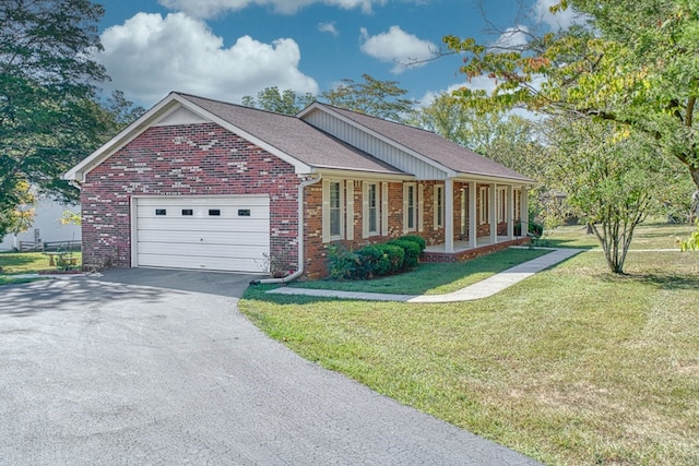 ranch-style home featuring a garage, brick siding, a shingled roof, driveway, and a front lawn