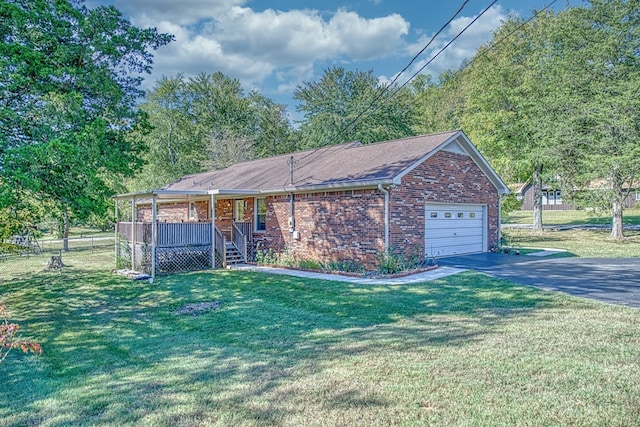 ranch-style home featuring an attached garage, brick siding, fence, driveway, and a front yard