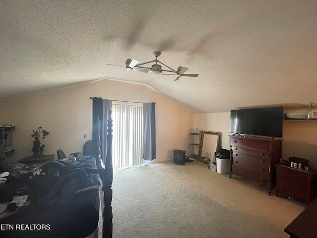 bedroom with lofted ceiling, ceiling fan, a textured ceiling, and carpet