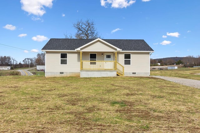 view of front facade with crawl space, covered porch, a shingled roof, and a front yard