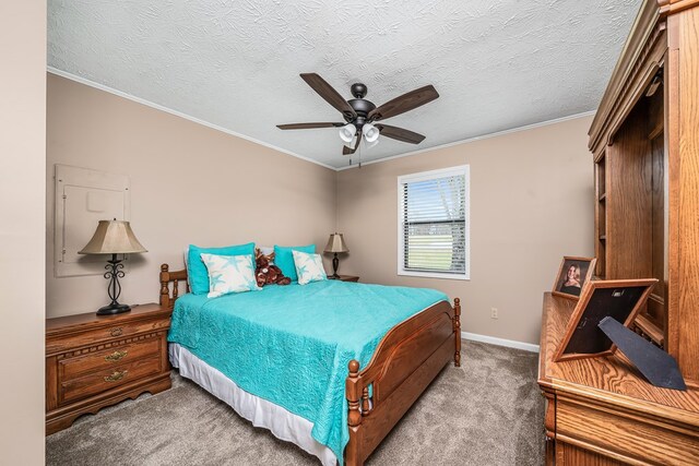 bedroom featuring carpet, a textured ceiling, ceiling fan, and crown molding