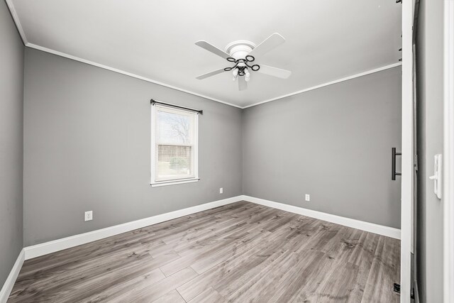 unfurnished room with ornamental molding, ceiling fan, light wood-style flooring, and baseboards