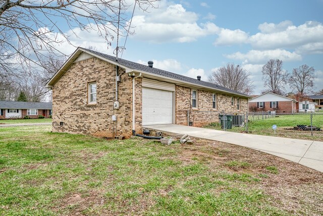 ranch-style home with driveway, fence, a front lawn, and brick siding