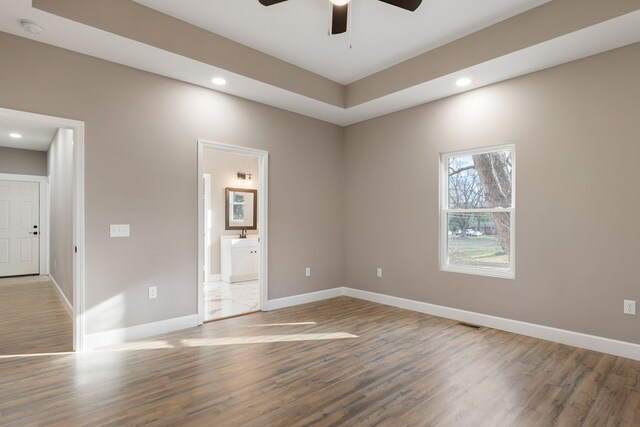 spare room with ceiling fan, recessed lighting, wood finished floors, visible vents, and baseboards