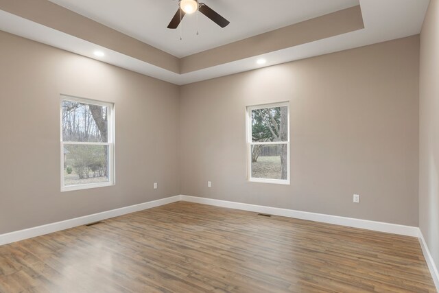 spare room featuring recessed lighting, ceiling fan, baseboards, and wood finished floors