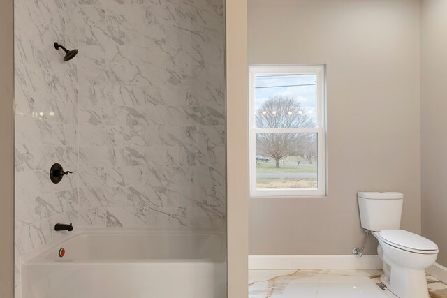 full bathroom featuring a wealth of natural light, marble finish floor, toilet, and baseboards