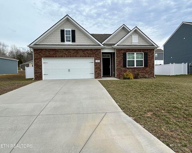 craftsman-style house with brick siding, a front lawn, fence, concrete driveway, and a garage