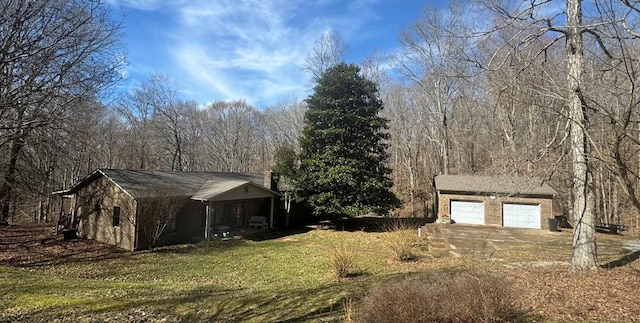 view of side of home featuring a yard and an outdoor structure