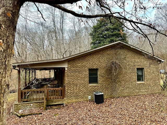 view of home's exterior featuring central AC and brick siding