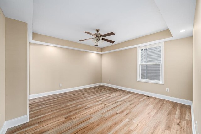 spare room featuring light wood-type flooring, ceiling fan, baseboards, and recessed lighting